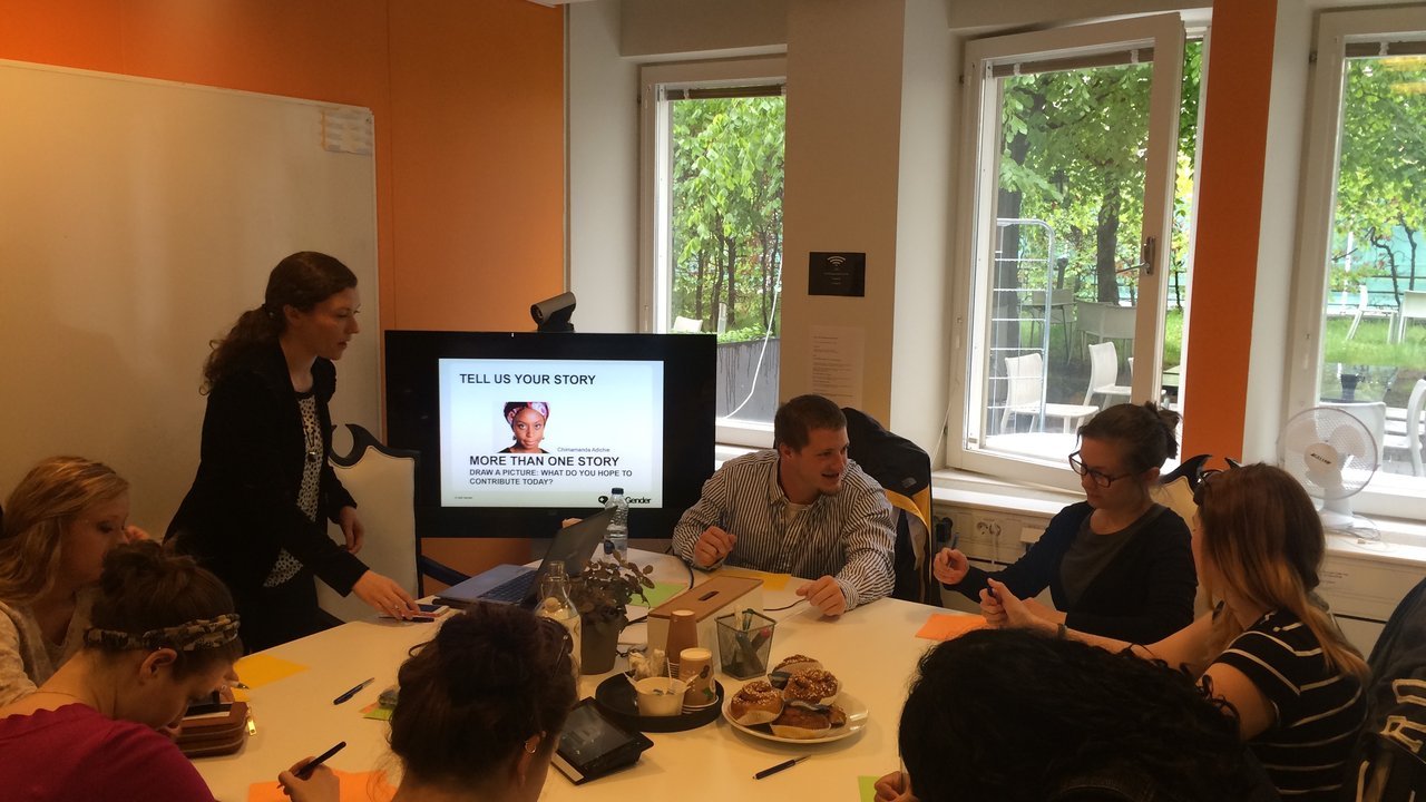 Students in a classroom workshop writing at a table